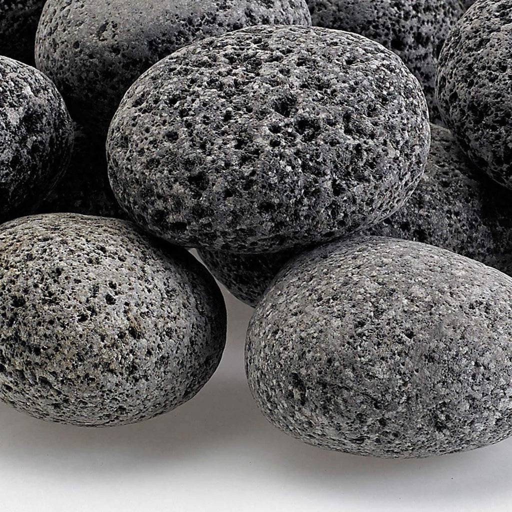 Gray lava stones close-up, porous rough surface on rounded medium rocks