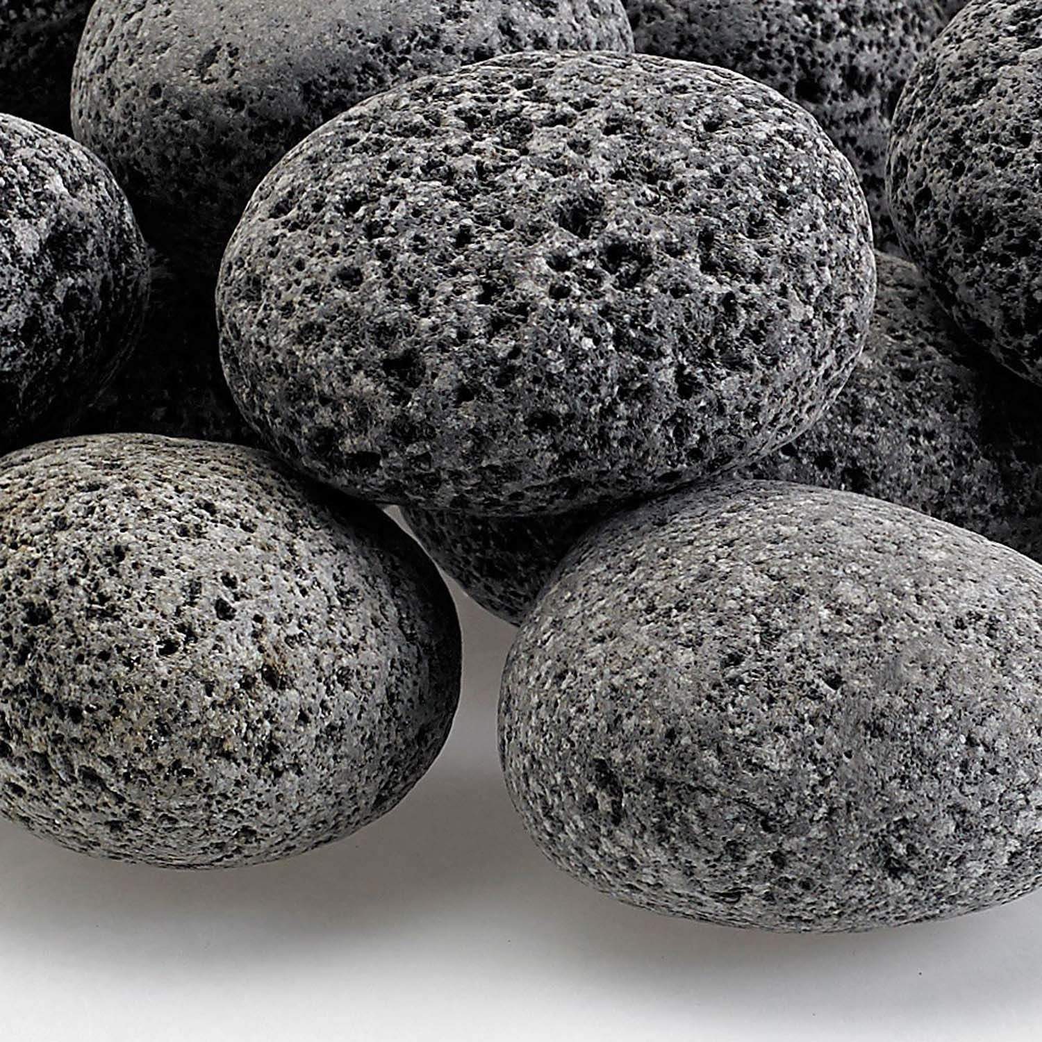 Gray lava stones close-up, porous rough surface on rounded medium rocks