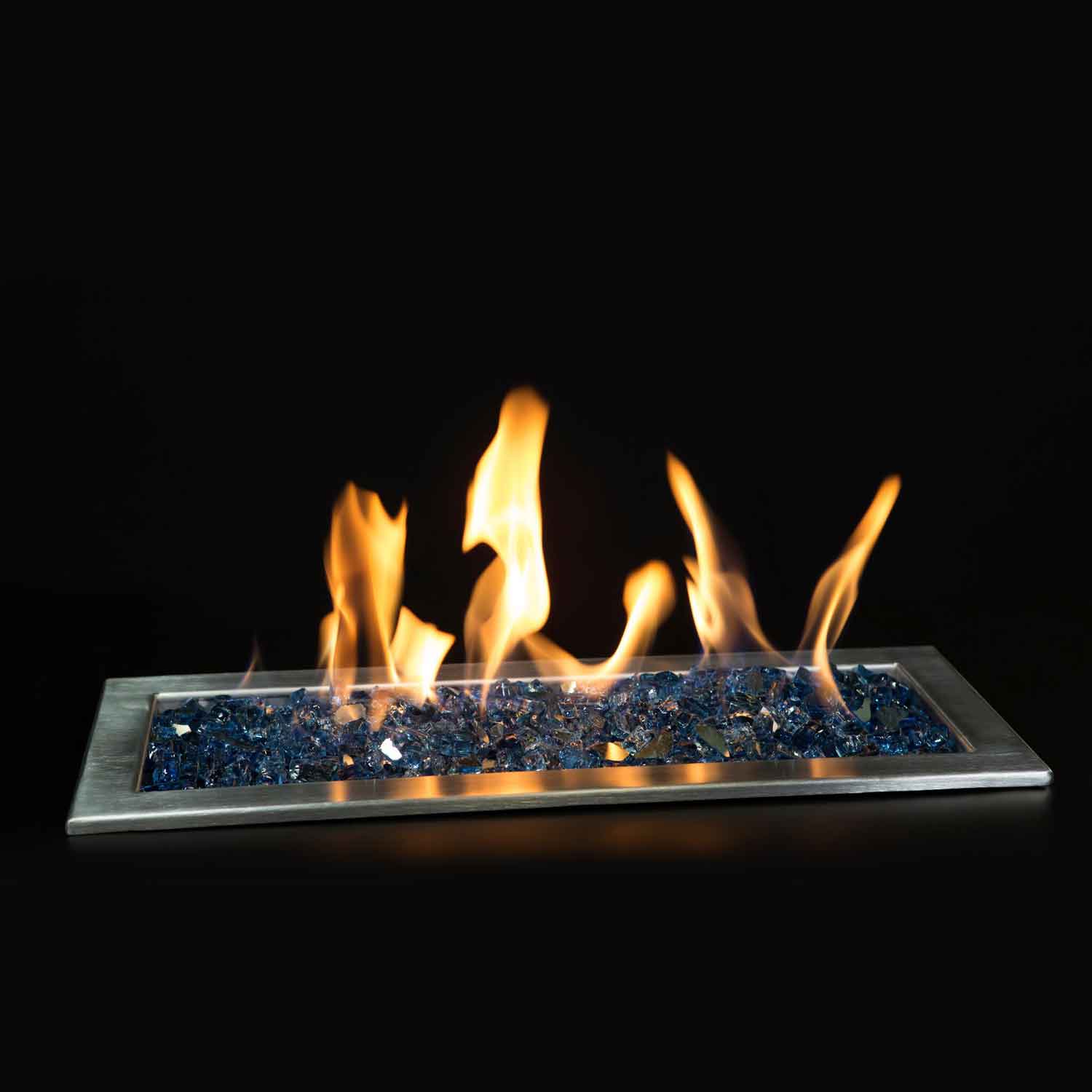 Reflective fire glass bed with blue chunks in a fire pit, with flames