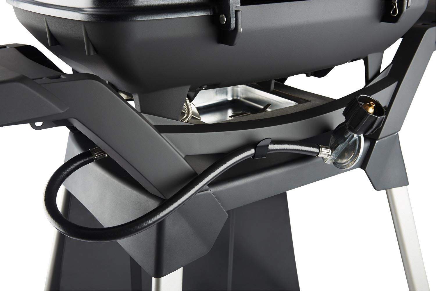 Gas grill cart close-up: black hose and valve/regulator near grill base