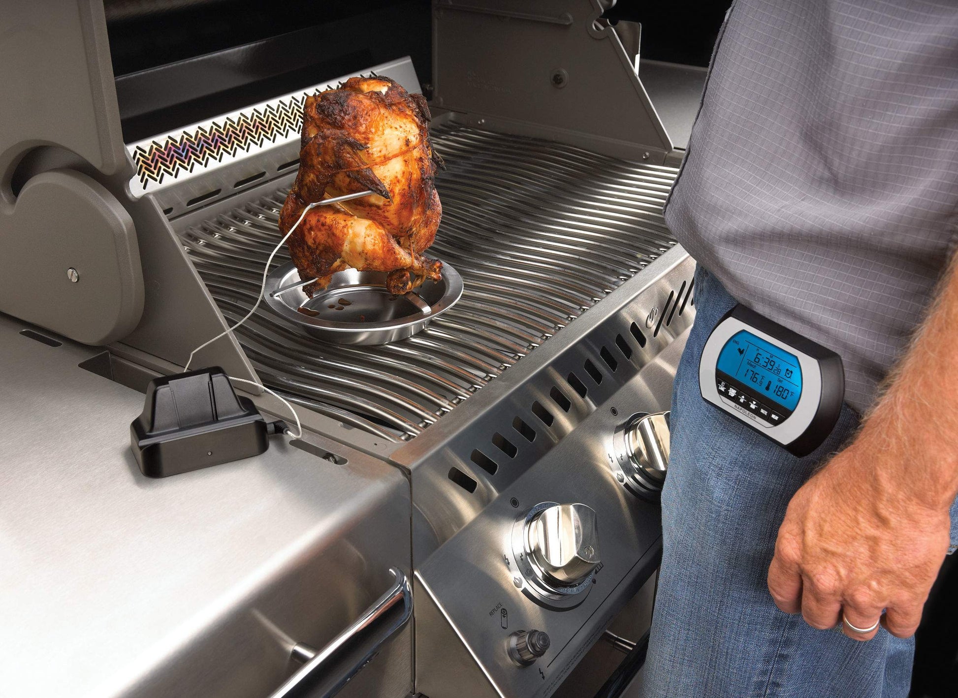 Napoleon wireless digital thermometer near grill, blue LCD reading with wire probe