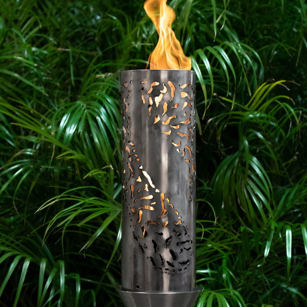 Tiki torch with stand, burning flame in metal lantern with cutout pattern
