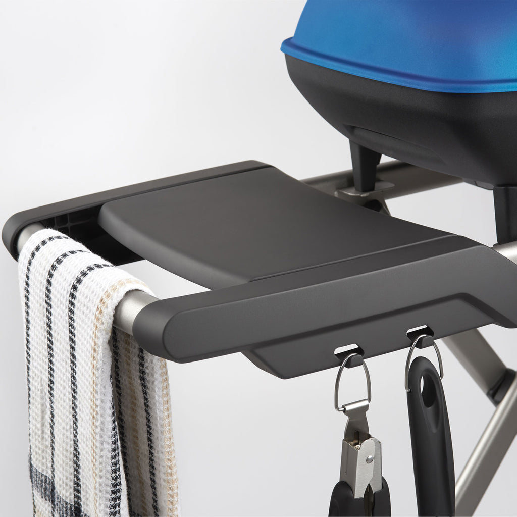 Portable propane grill side shelf with hanging hooks and black ignition knobs
