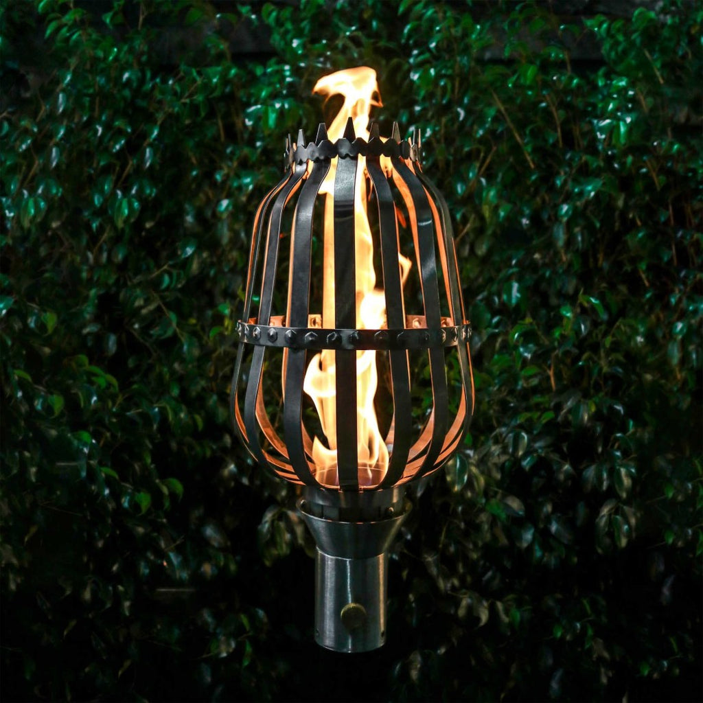 Outdoor urn top flame torch with metal cage and steady black stand, burning flame