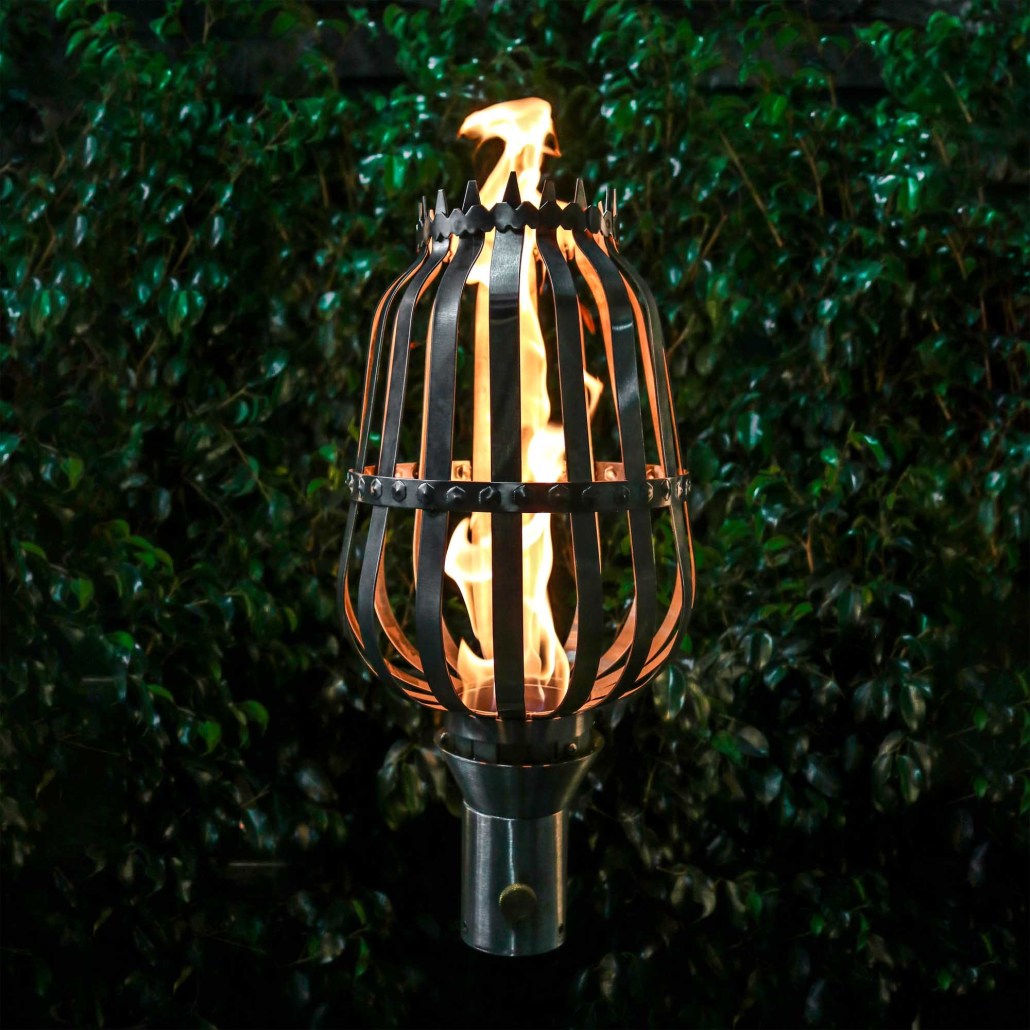 Outdoor urn top flame torch with metal cage and steady black stand, burning flame