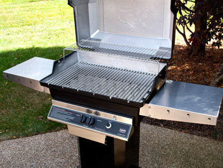 Open gas grill with stainless cooking grate and side shelf extended